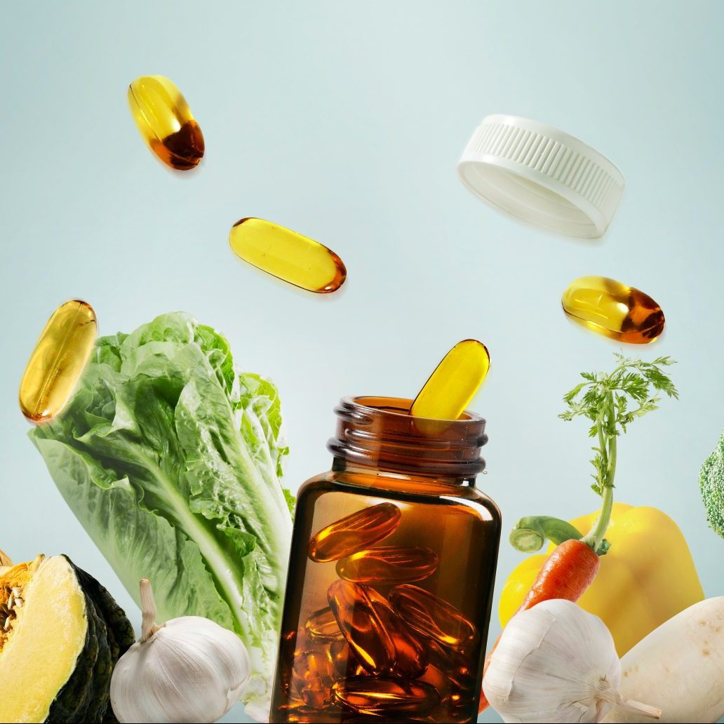 “Healthy vitamins, fresh vegetables, and dietary supplements are displayed on a blue background, emphasizing the health benefits and a balanced lifestyle.”